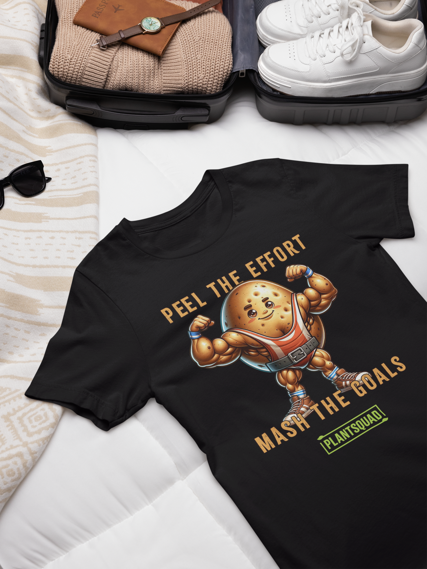 A black T-shirt featuring an illustration of a muscular potato flexing its arms. Above the potato, text reads "PEEL THE EFFORT." Below, text reads "MASH THE GOALS." Perfect for fitness enthusiasts, this vegan T-shirt showcases a small green rectangular logo at the bottom that says "PLANTSQUAD. The product name is Plantsquad Potato  "Peel The Effort Mash The Goals" - Unisex T-Shirt.