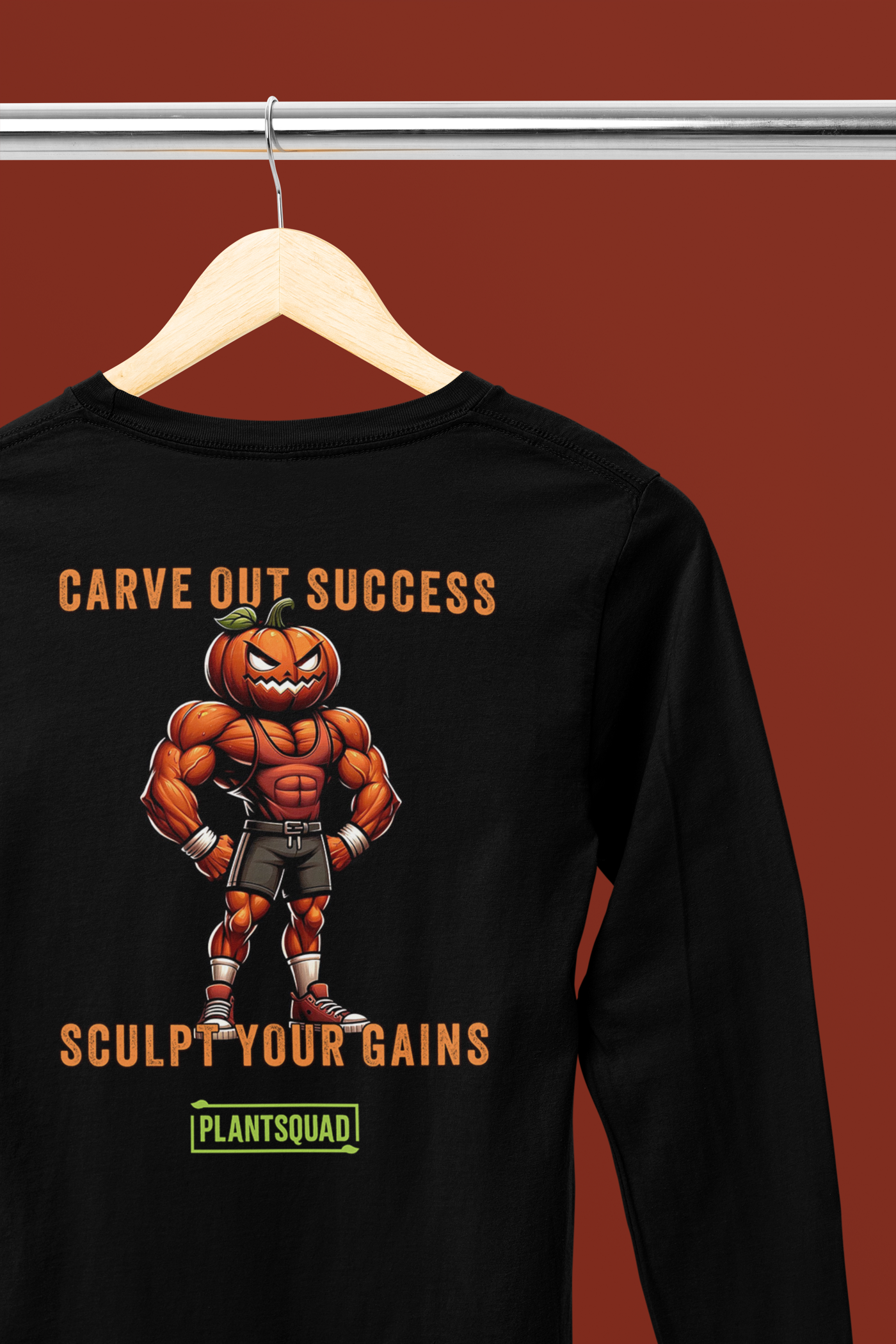 The Plantsquad Pumpkin "Carve Out Your Success Sculpt Your Gains" - Unisex Long Sleeve T-Shirt features an illustration of a muscly pumpkin cartoon figure in fitness attire. The text on the shirt reads, "Carve Out Success, Sculpt Your Gains," with "Plant based lifestyle" below the figure.