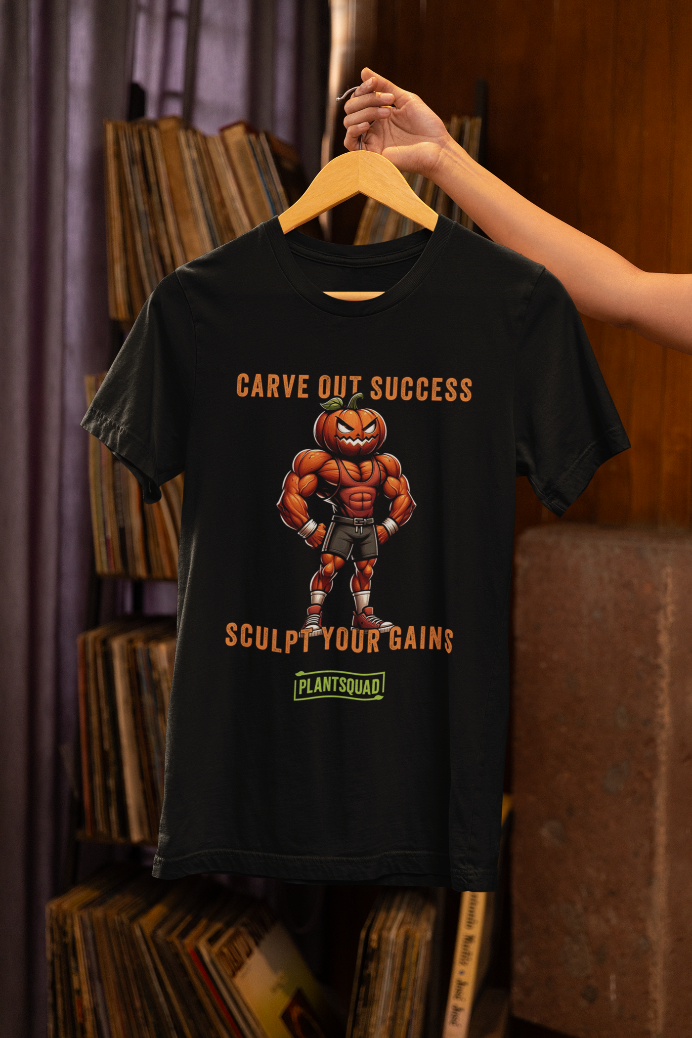 Plantsquad Pumpkin "Carve Out Your Success Sculpt Your Gains" - Unisex T-Shirt featuring a muscular pumpkin-headed character in gym attire. The text above the character says "CARVE OUT SUCCESS," and below reads "SCULPT YOUR GAINS." Perfect for fitness enthusiasts and those embracing a plant-based lifestyle, the bottom text says "PLANTSQUAD" in a green box.