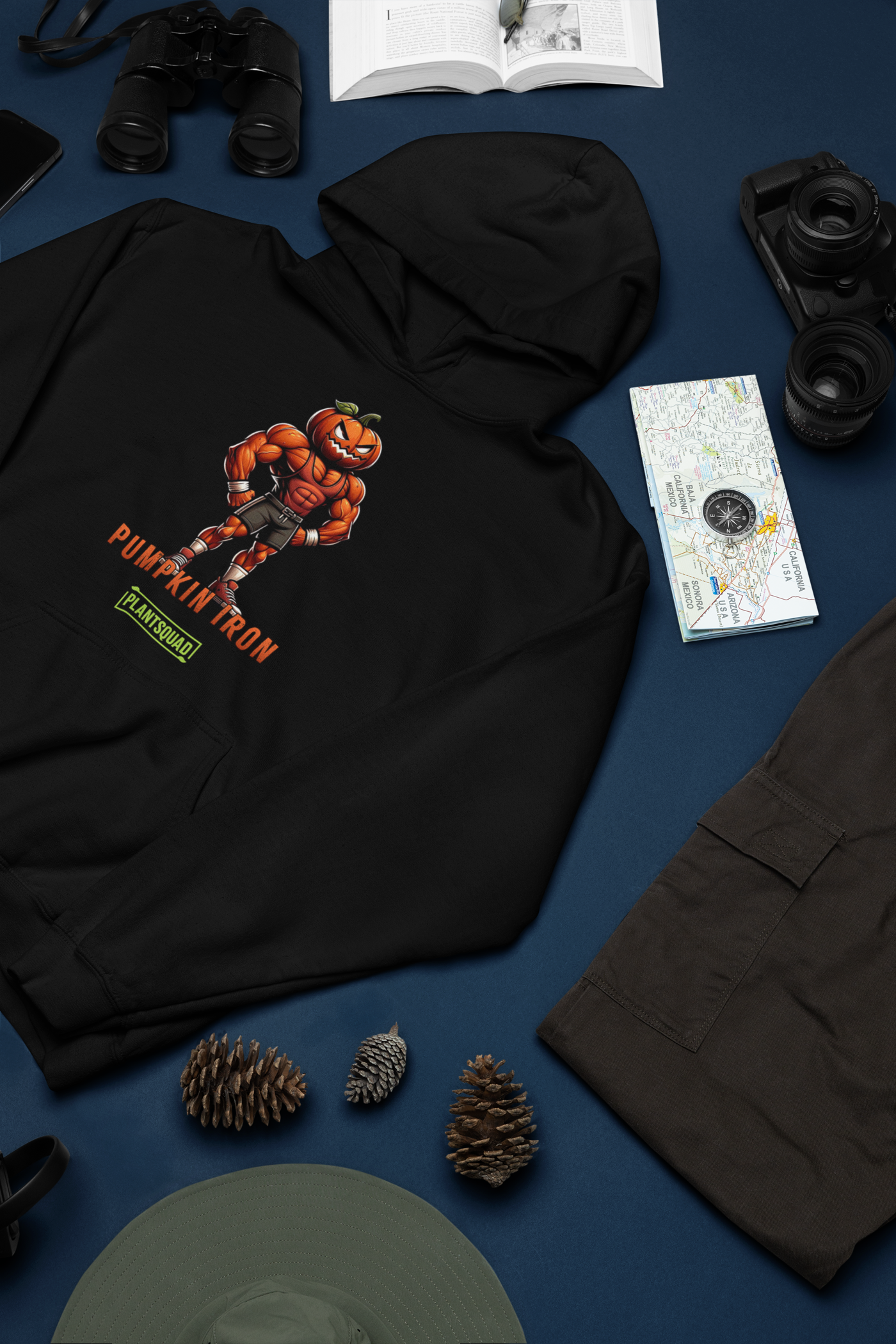 The Plantsquad Pumpkin "Pumpkin Iron" - Unisex Hoodie showcases a muscular pumpkin design, with a cartoon character flexing its muscles under the text "PUMPKIN IRON" in vibrant orange. Below, a green bar labeled "PLANTSQUAD" represents the vegan lifestyle, creating the perfect blend of fitness and plant-based living.