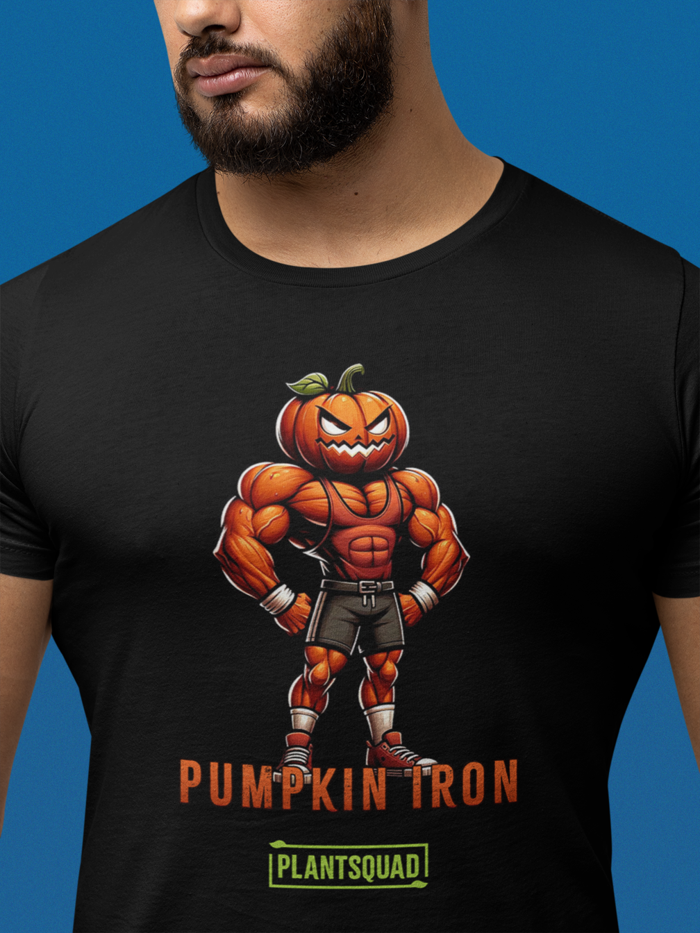 A Plantsquad Pumpkin "Pumpkin Iron" - Unisex T-Shirt featuring a muscular pumpkin-headed character flexing its arms. The character is wearing shorts, trainers, and gloves. The text "PUMPKIN IRON" is displayed in bold orange letters below the character, with "PLANTSQUAD" in green beneath it—perfect for fitness enthusiasts with a vegan lifestyle.