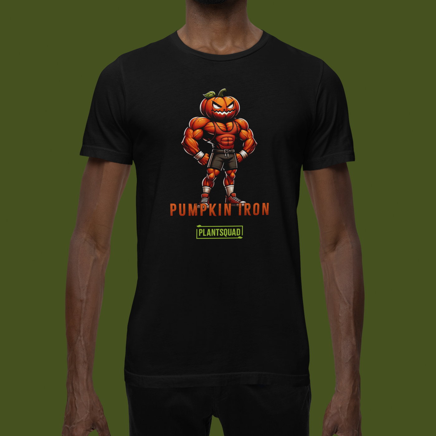 A Plantsquad Pumpkin "Pumpkin Iron" - Unisex T-Shirt featuring a muscular pumpkin-headed character flexing its arms. The character is wearing shorts, trainers, and gloves. The text "PUMPKIN IRON" is displayed in bold orange letters below the character, with "PLANTSQUAD" in green beneath it—perfect for fitness enthusiasts with a vegan lifestyle.