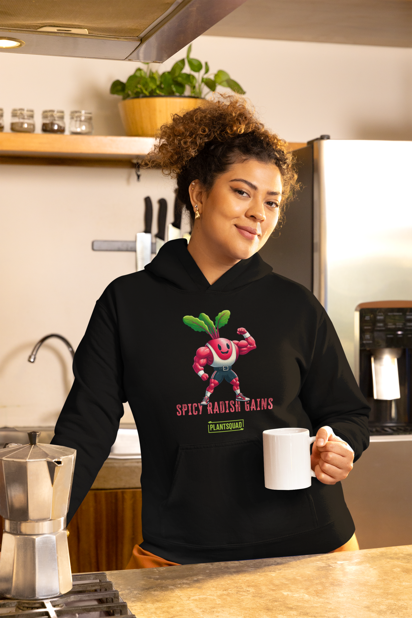 A Plantsquad Radish "Spicy Radish Gains" - Unisex Hoodie made of cozy fabric displays a cartoon radish character with muscular arms, flexing one arm. The radish has a smiling face and green leaves on top. Below it, the text reads "SPICY RADISH GAINS" in bold red letters, with a green banner reading "PLANTSQUAD" underneath—a perfect fit for the vegan lifestyle and weight lifting enthusiasts.