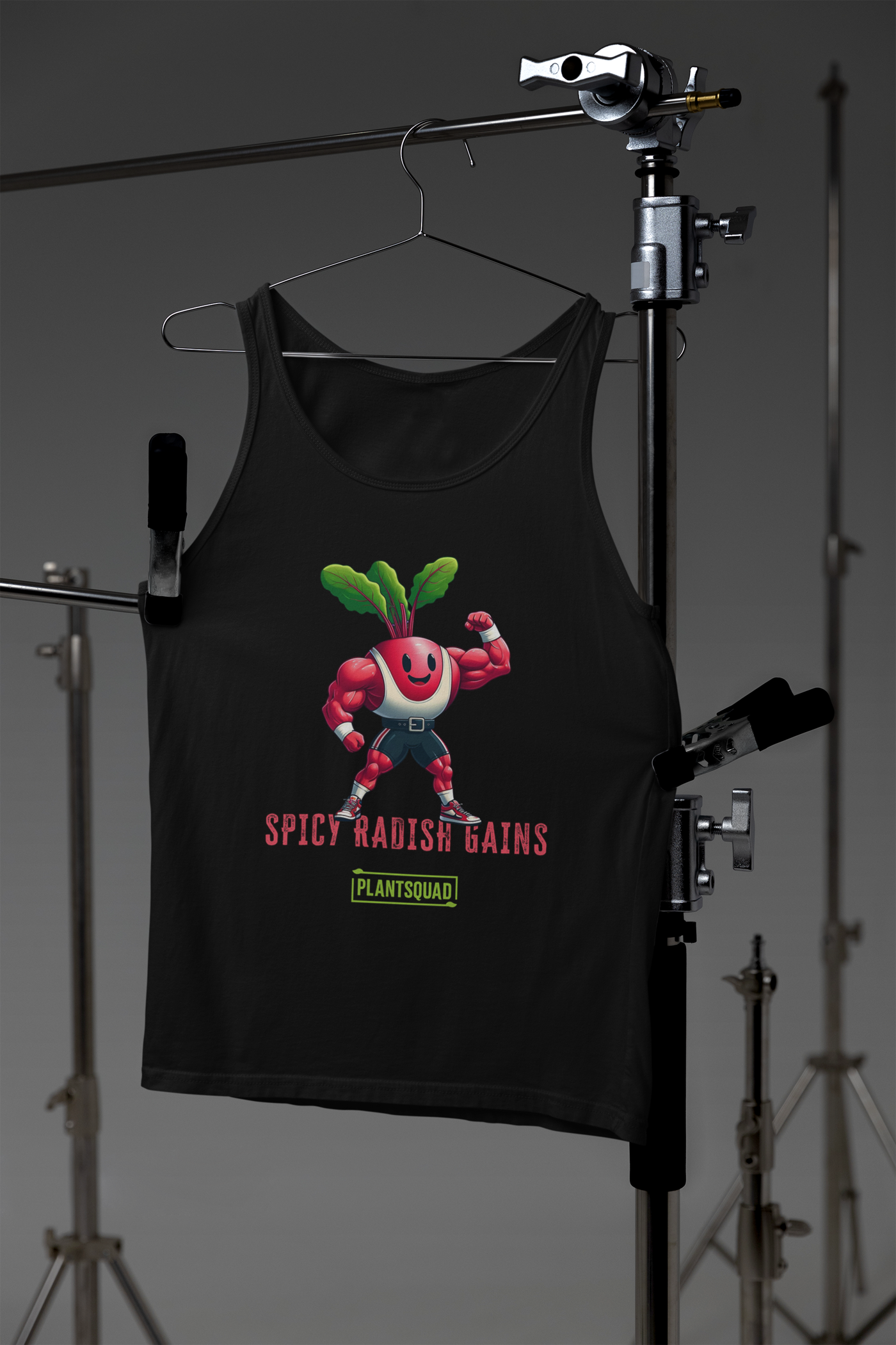 A black tank top featuring a cartoon radish character with muscular arms flexing, smiling, and wearing sneakers. The text "SPICY RADISH GAINS" is printed below the character, celebrating a plant-based lifestyle with "PLANTSQUAD" in a green box beneath the main text. Perfect vegan gym wear! Introducing the Plantsquad Radish "Spicy Radish Gains" - Unisex Tank Top.