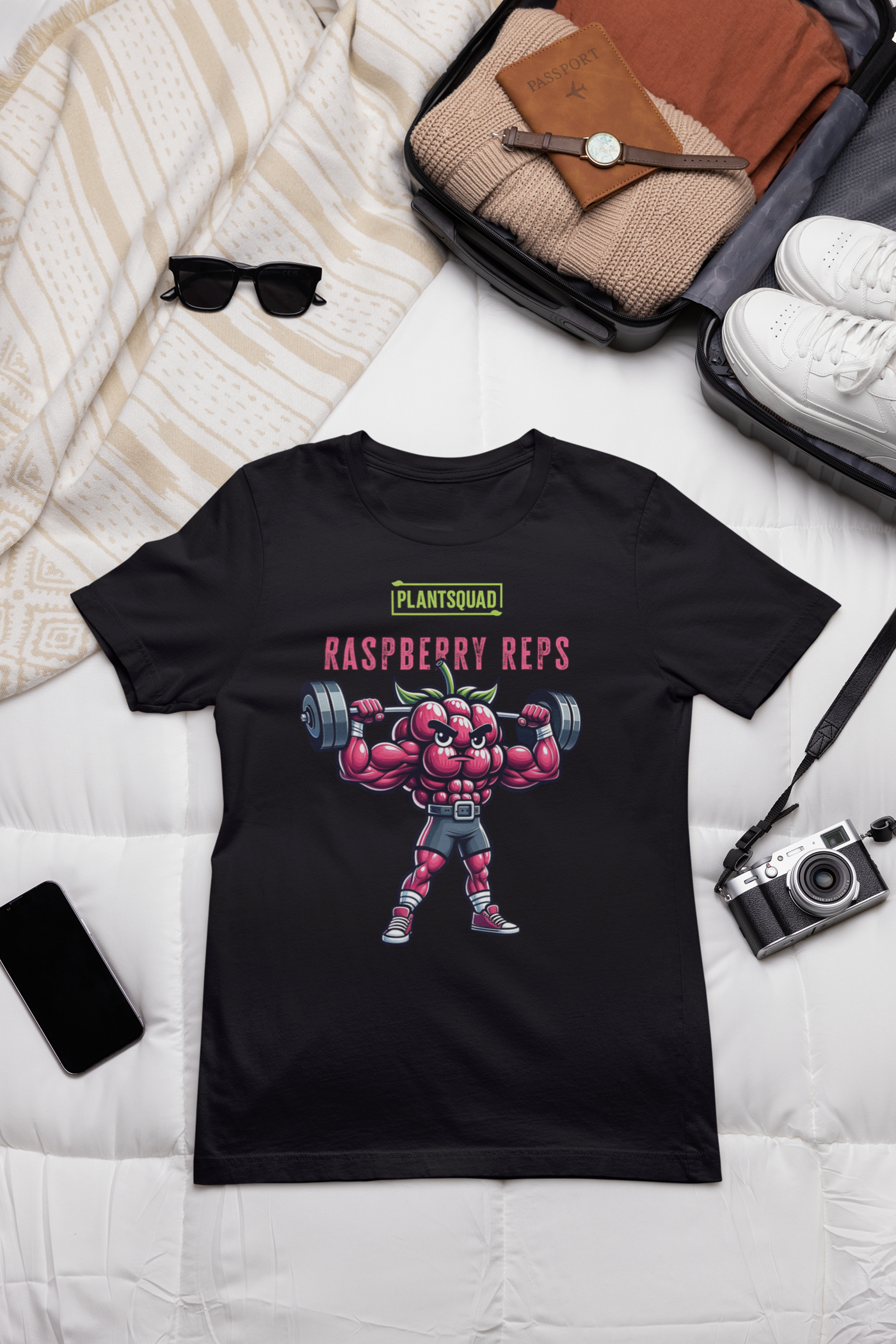 A black Plantsquad Raspberry "Raspberry Reps" - Unisex T-Shirt features a muscular raspberry lifting weights. Above the raspberry, the text reads "PLANTSQUAD" in green and "RASPBERRY REPS" in pink. The flexing raspberry character highlights vegan fitness while holding dumbbells—a perfect addition to your plant-based lifestyle collection.