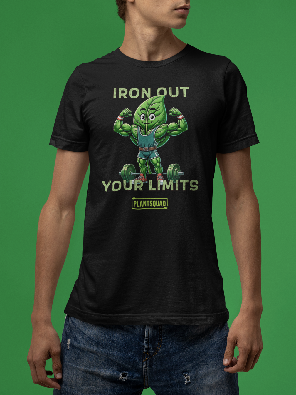 A black Plantsquad Spinach "Iron Out Your Limits" - Unisex T-Shirt featuring a muscular cartoon green leaf character lifting a barbell, with the text "IRON OUT YOUR LIMITS" above and below the character. Embrace your vegan lifestyle with the word "PLANTSQUAD" at the bottom in a small rectangular green box.