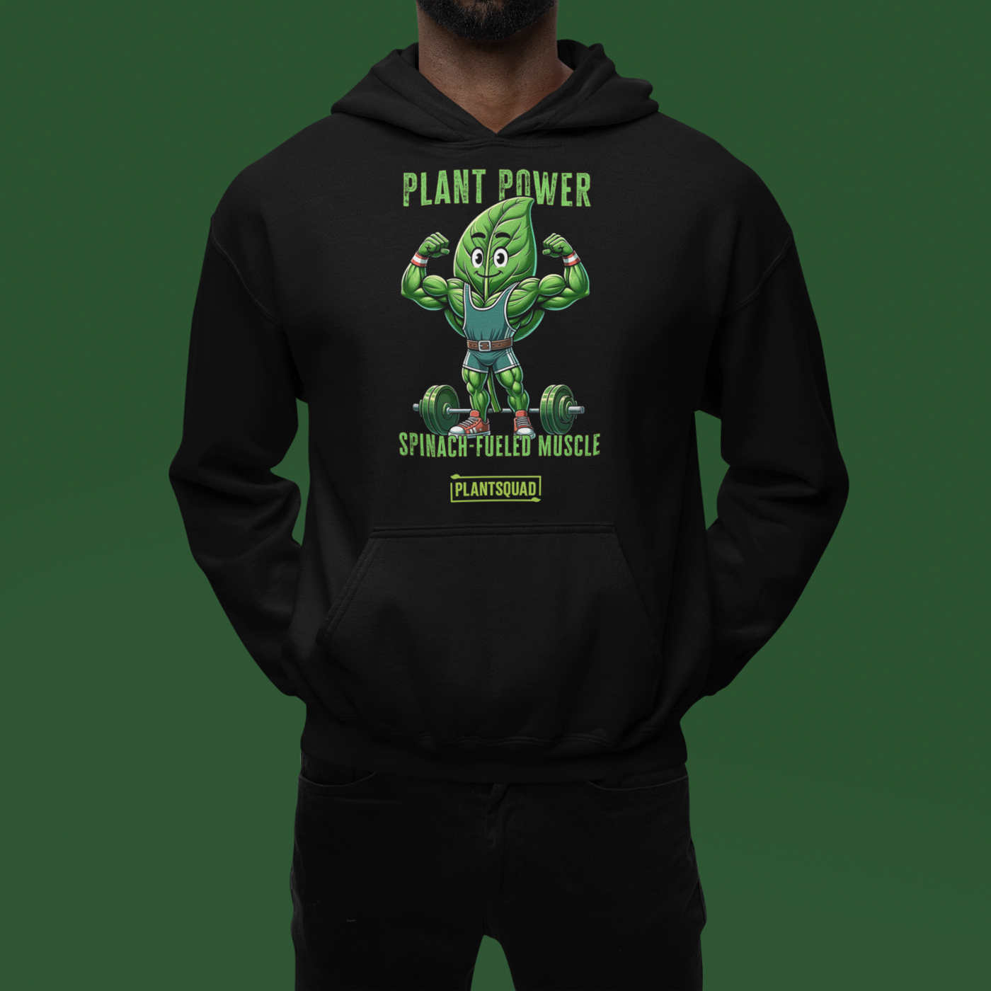 The Plantsquad Spinach "Plant Power Spinach Fueled Muscle" - Unisex Hoodie features a muscular cartoon spinach leaf character lifting weights with the text "PLANT POWER" above and "SPINACH FUELED MUSCLE" below. Perfect for gym enthusiasts embracing a vegan lifestyle, there’s a small "PLANTSQUAD" label at the bottom.