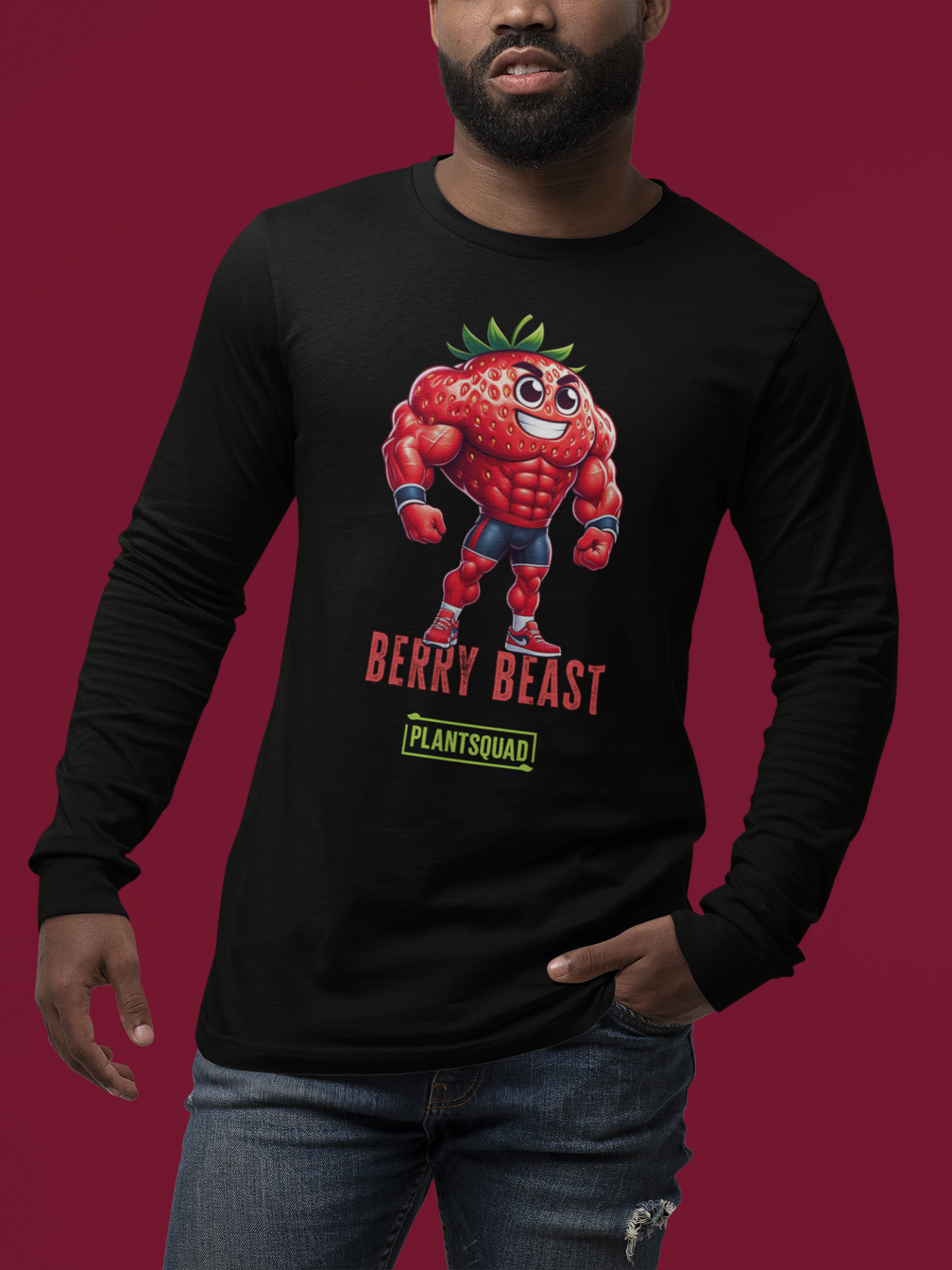 The Plantsquad Strawberry "Berry Beast" - Unisex Long Sleeve T-Shirt features a muscly strawberry cartoon character with the text "Berry Beast" in bold red and purple letters above the word "Plantsquad" in a green box. Perfect for fitness enthusiasts embracing a vegan lifestyle, this design showcases strength in style.