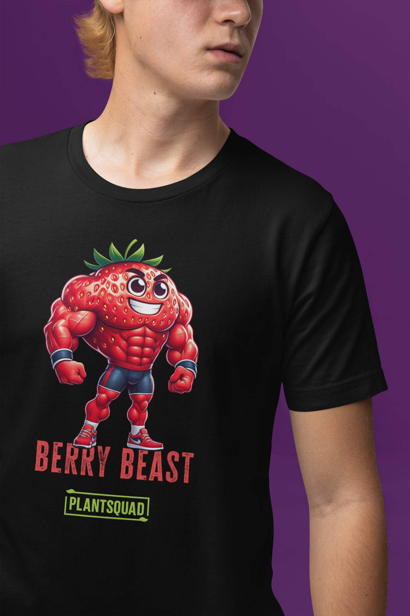 A black T-shirt displays a muscular cartoon strawberry character with arms crossed, wearing sneakers. Perfect for fitness enthusiasts, the design features "BERRY BEAST" in red and "PLANTSQUAD" in green, making it ideal for those embracing a vegan lifestyle. This is the Plantsquad Strawberry "Berry Beast" - Unisex T-Shirt.