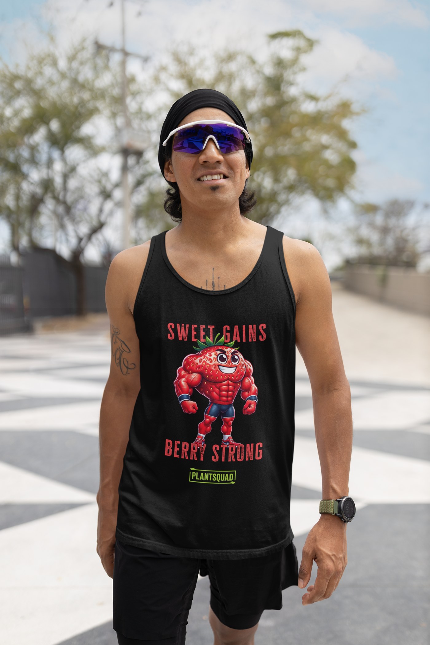 A black Plantsquad Strawberry "Sweet Gains Berry Strong" - Unisex Tank Top featuring a muscular, anthropomorphic strawberry character flexing. Above the strawberry, text reads "Sweet Gains," and below it, "Berry Strong." At the bottom, a green logo with the text "Plantsquad." Perfect for showcasing your plant-based lifestyle in the gym.