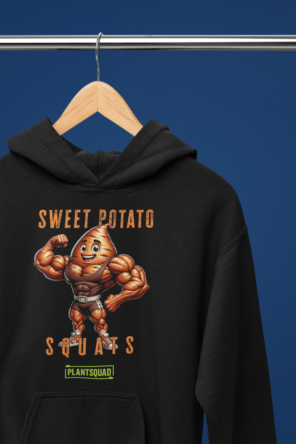 A black Plantsquad Sweet Potato "Sweet Potato Squats" - Unisex Hoodie featuring a muscular anthropomorphic sweet potato flexing its arms. The text above reads "Sweet Potato Squats" and below reads "Plantsquad." The sweet potato character is smiling, wearing a weightlifting belt, and the cozy fabric makes it perfect for anyone embracing the vegan lifestyle.