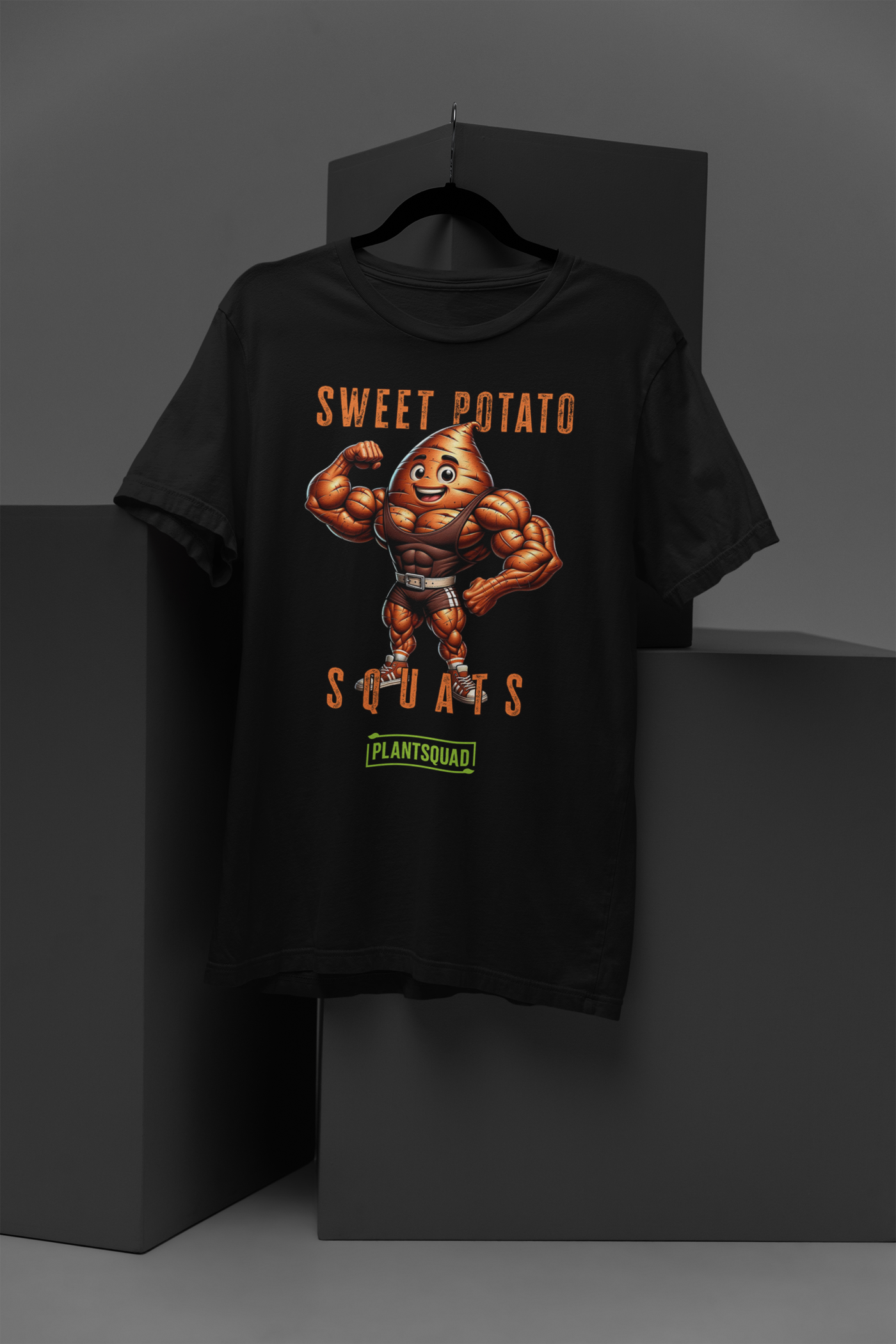 A Plantsquad Sweet Potato "Sweet Potato Squats" - Unisex T-Shirt featuring a muscular cartoon sweet potato character flexing its biceps. The text above the character reads "Sweet Potato" and below it reads "Squats." There is a green logo at the bottom with the text "PLANTSQUAD." Perfect for vegan fitness enthusiasts embracing a plant-based lifestyle.