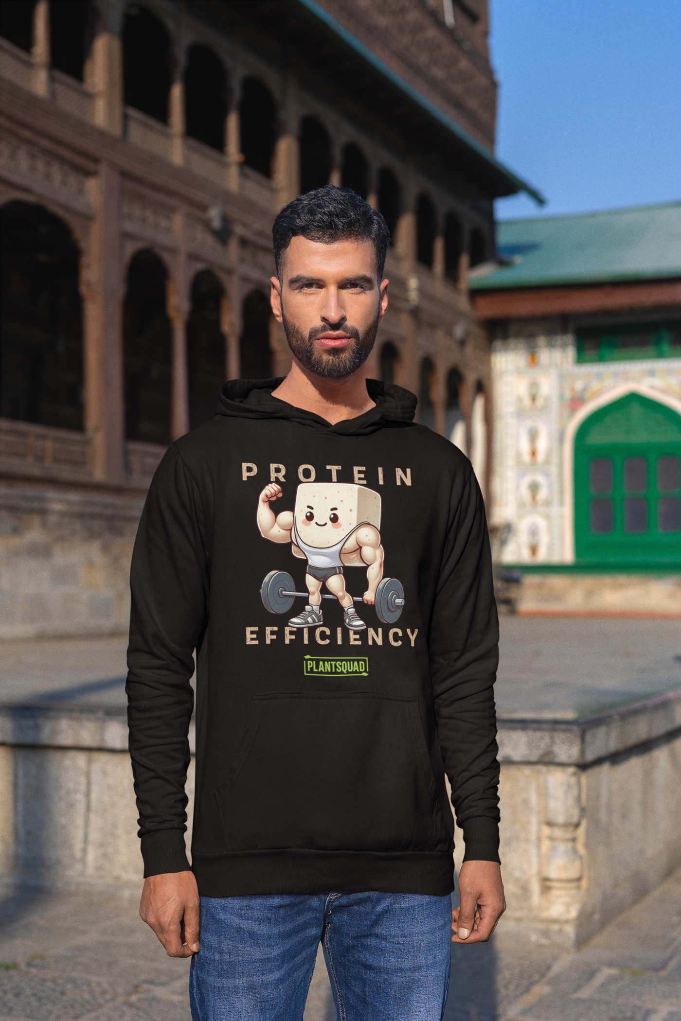 This Plantsquad Tofu "Protein Efficiency" - Unisex Hoodie features an illustration of a muscular cartoon tofu character lifting a barbell, celebrating the vegan lifestyle. The text above and below reads "PROTEIN EFFICIENCY." Below the illustration, there's a small logo that says "PLANTSQUAD.