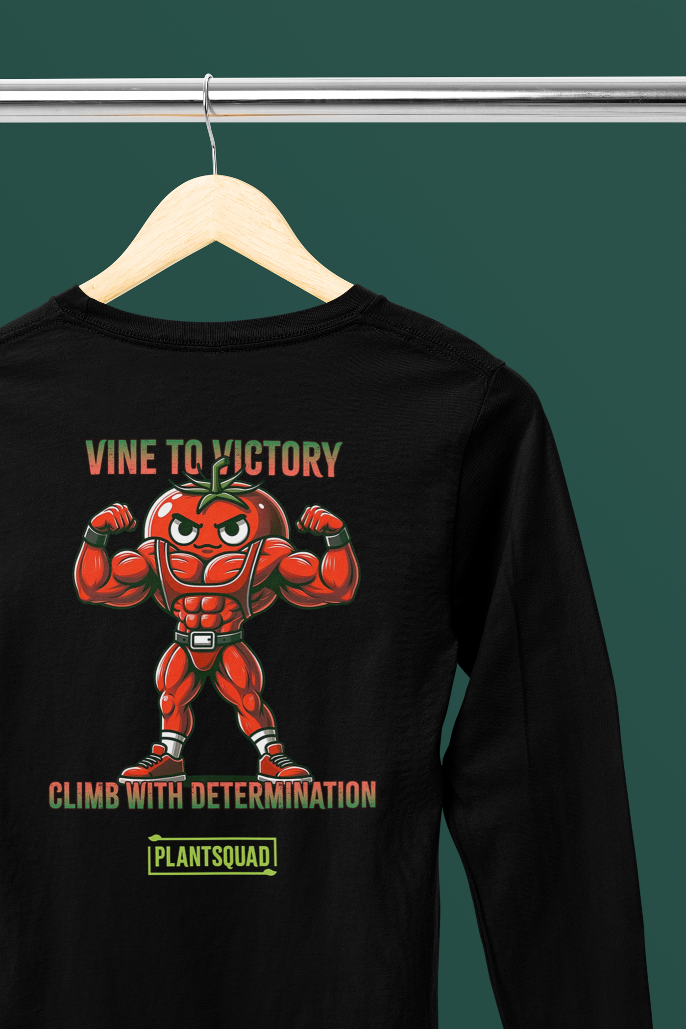 The Plantsquad Tomato "Vine To Victory Climb With Determination" - Unisex Long Sleeve T-Shirt features a muscly tomato design, with a cartoon tomato character flexing its arms. Above it, the text reads "Vine to Victory." Below the tomato, the text says "Climb with Determination." Below that is the word "PlantSquad" in a green box—perfect for fitness enthusiasts and those embracing a vegan lifestyle.