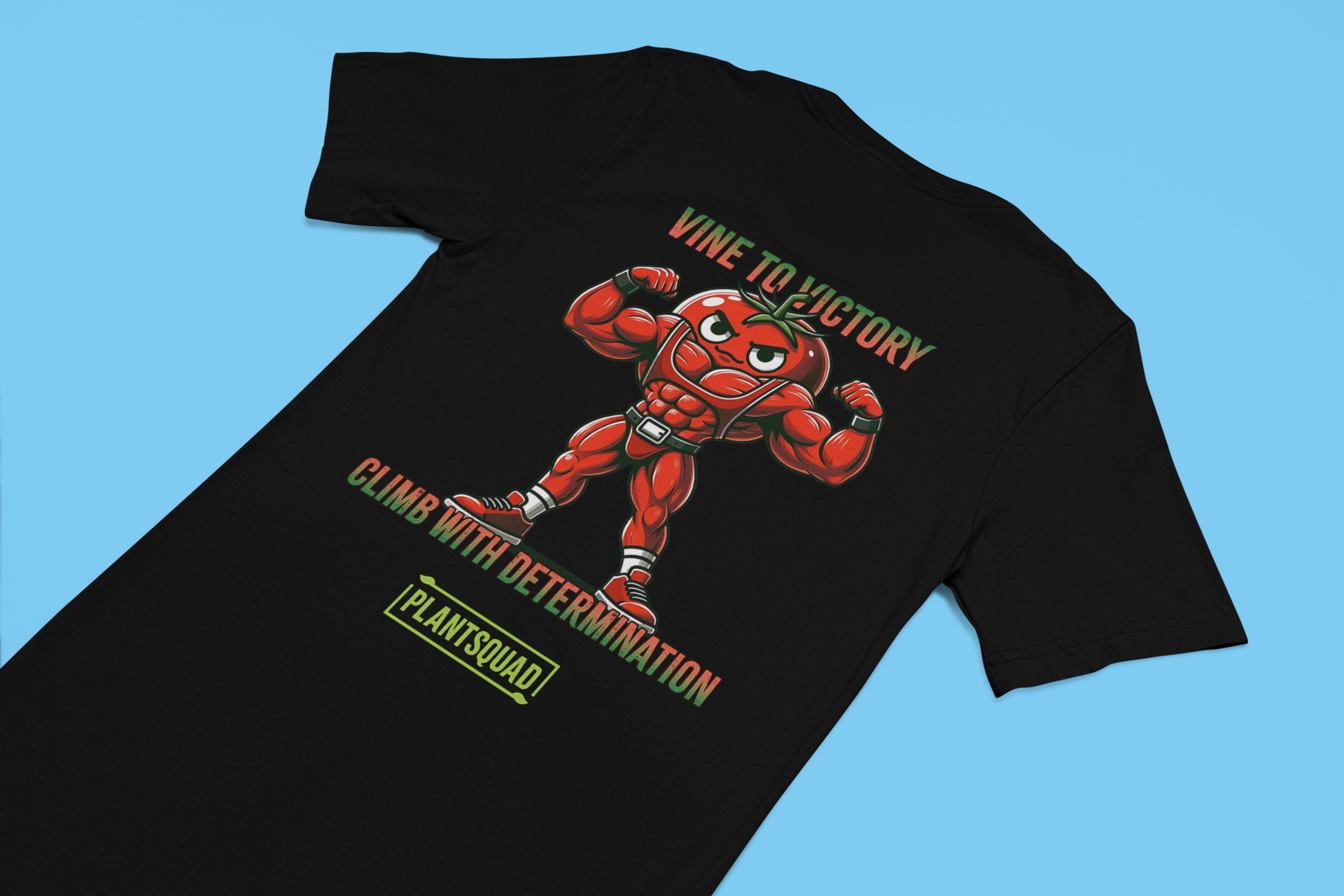 A Plantsquad Tomato "Vine To Victory Climb With Determination" - Unisex T-Shirt featuring an illustration of a muscular, anthropomorphic tomato flexing its arms. Perfect for fitness enthusiasts, the text above reads "Vine to Victory," and below, it says "Climb with Determination." The word "Plantsquad" is written at the bottom in a green box.