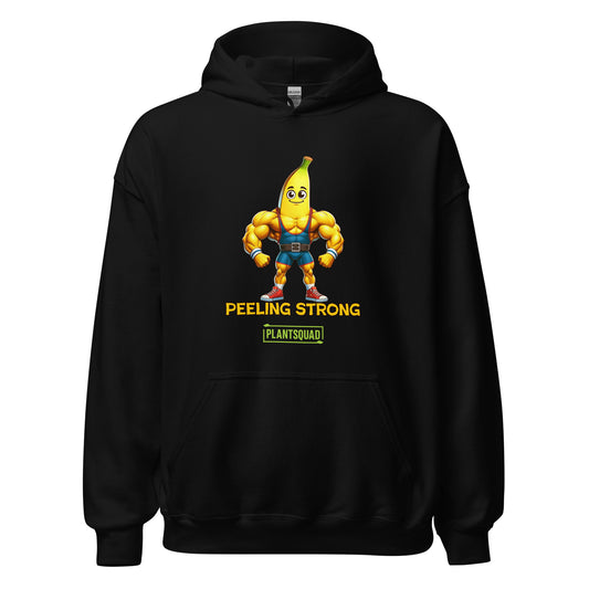 A Plantsquad Banana "Peeling Strong" - Unisex Hoodie features a cartoon banana with muscular arms and legs, wearing shorts and a weightlifting belt. The text reads "PEELING STRONG" above "PLANTSQUAD," perfect for those embracing a vegan lifestyle.