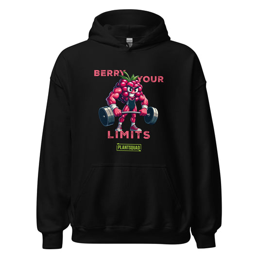 A black hoodie with a printed cartoon image of a muscular strawberry character lifting dumbbells. The text above reads "Berry Your Limits," perfect for those embracing a vegan gym wear style, and "Plantsquad" is written below the character. Introducing the Plantsquad Raspberry "Berry Your Limits" - Unisex Hoodie.