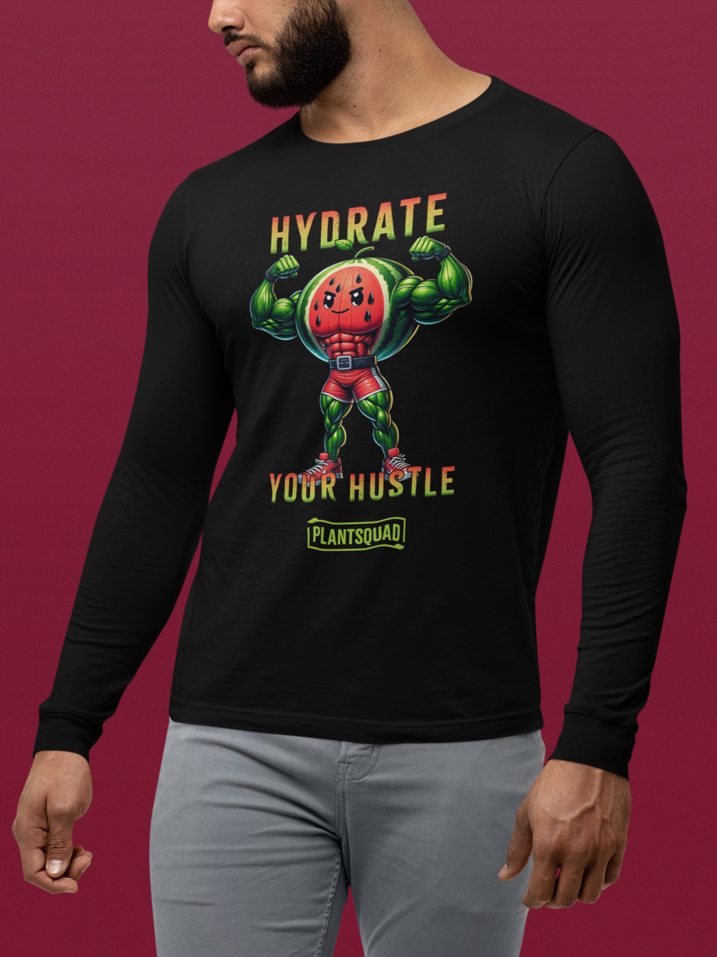 Plantsquad Watermelon "Hydrate Your Hustle" - Unisex Long Sleeve T-Shirt featuring a muscular anthropomorphic watermelon holding a water bottle. Text above the character reads, "Hydrate Your Hustle" in bold letters, and below it says "PlantSquad." The design is vibrant with a superhero theme, perfect for those embracing a vegan fitness journey.