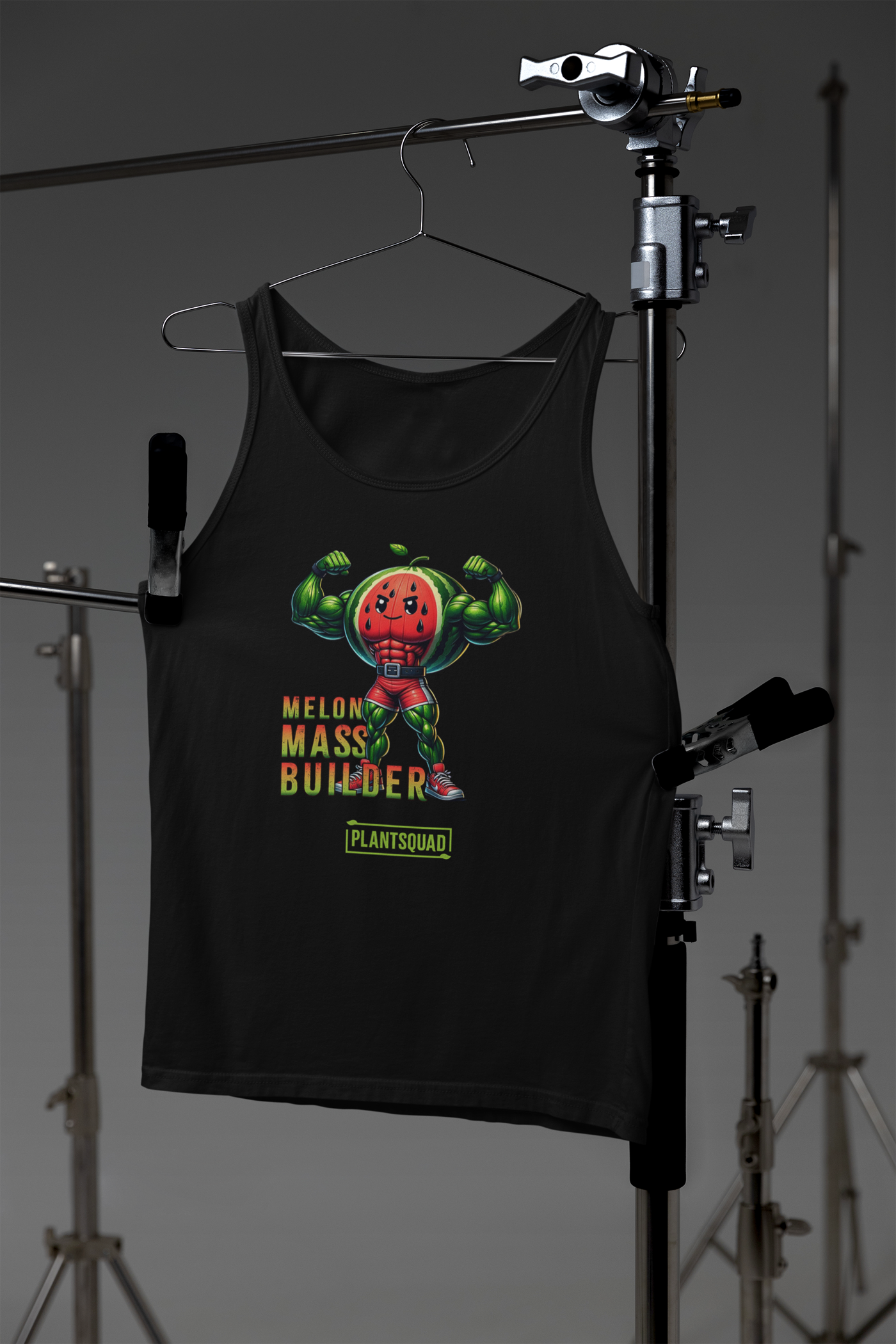 A Plantsquad Watermelon "Melon Mass Builder" - Unisex Tank Top featuring a graphic of a muscular watermelon character flexing its biceps. The text "Melon Mass Builder" and "Plant Squad" are displayed in stylized fonts near the character, making it an ideal piece of plant based workout apparel.