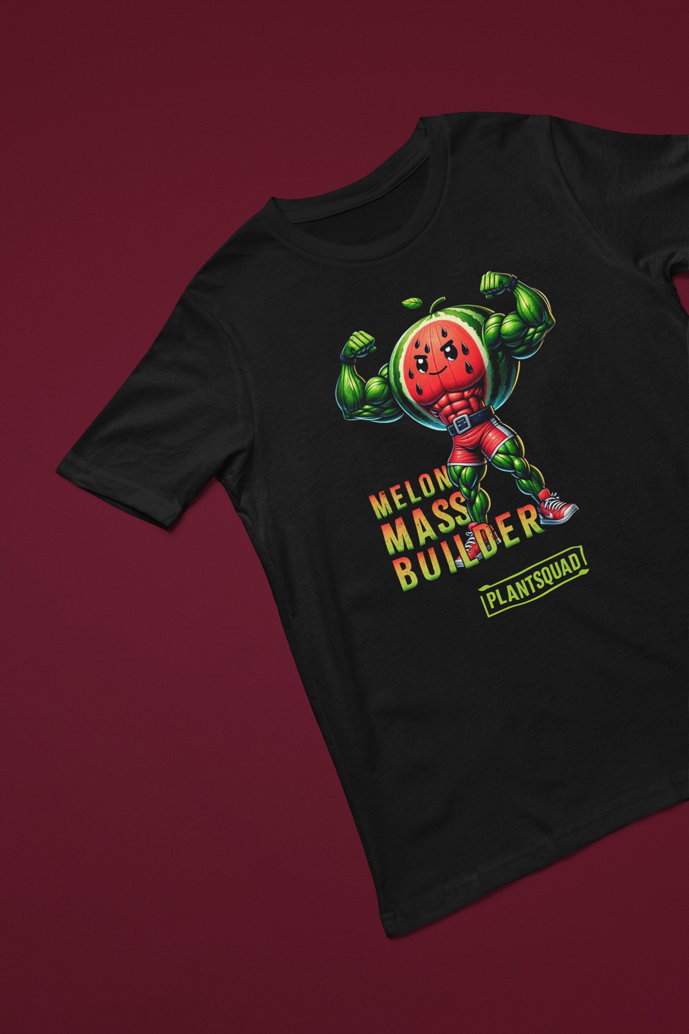 A black gym T-shirt features a muscly watermelon cartoon character flexing its arms. The text reads "Melon Mass Builder" in large colorful letters, with "Plant Squad" written below. Perfect for those embracing a vegan lifestyle, the design is bold and vibrant. The product name is: Plantsquad Watermelon "Melon Mass Builder" - Unisex T-Shirt.