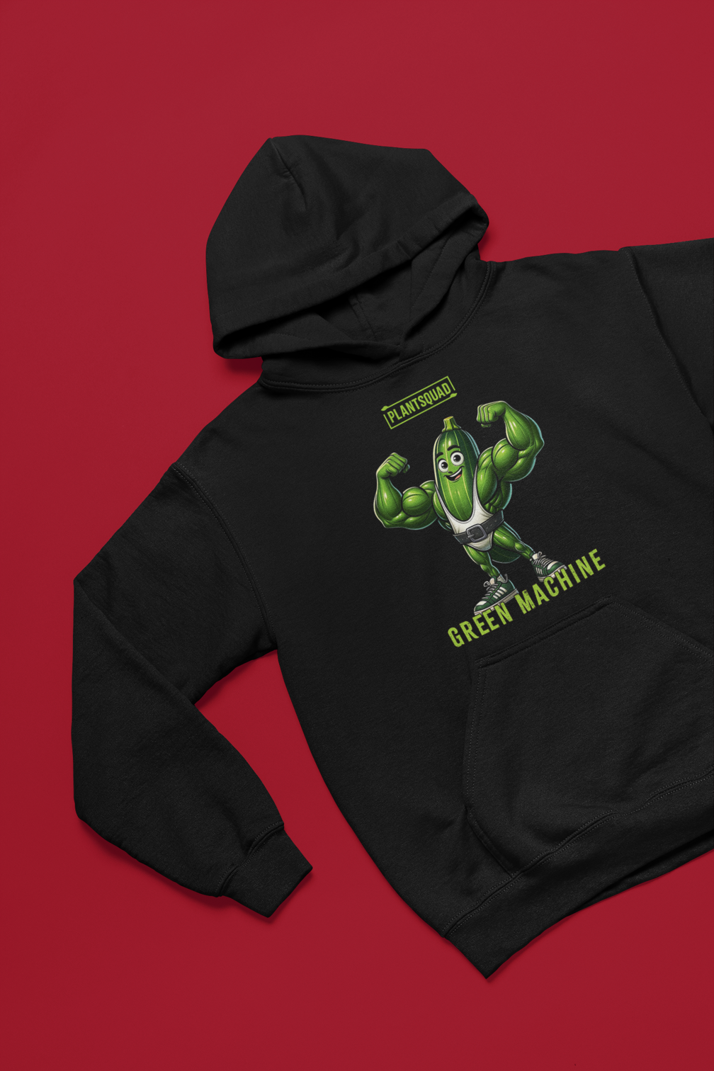 A black hoodie featuring a muscular cucumber character flexing its arms. Above the character, the text reads "PLANTSQUAD," and below it, "GREEN MACHINE" in lime-green, blocky font. This Plantsquad Zucchini "Green Machine" - Unisex Hoodie has a front pocket and a drawstring hood, perfect for those embracing a plant-based lifestyle.